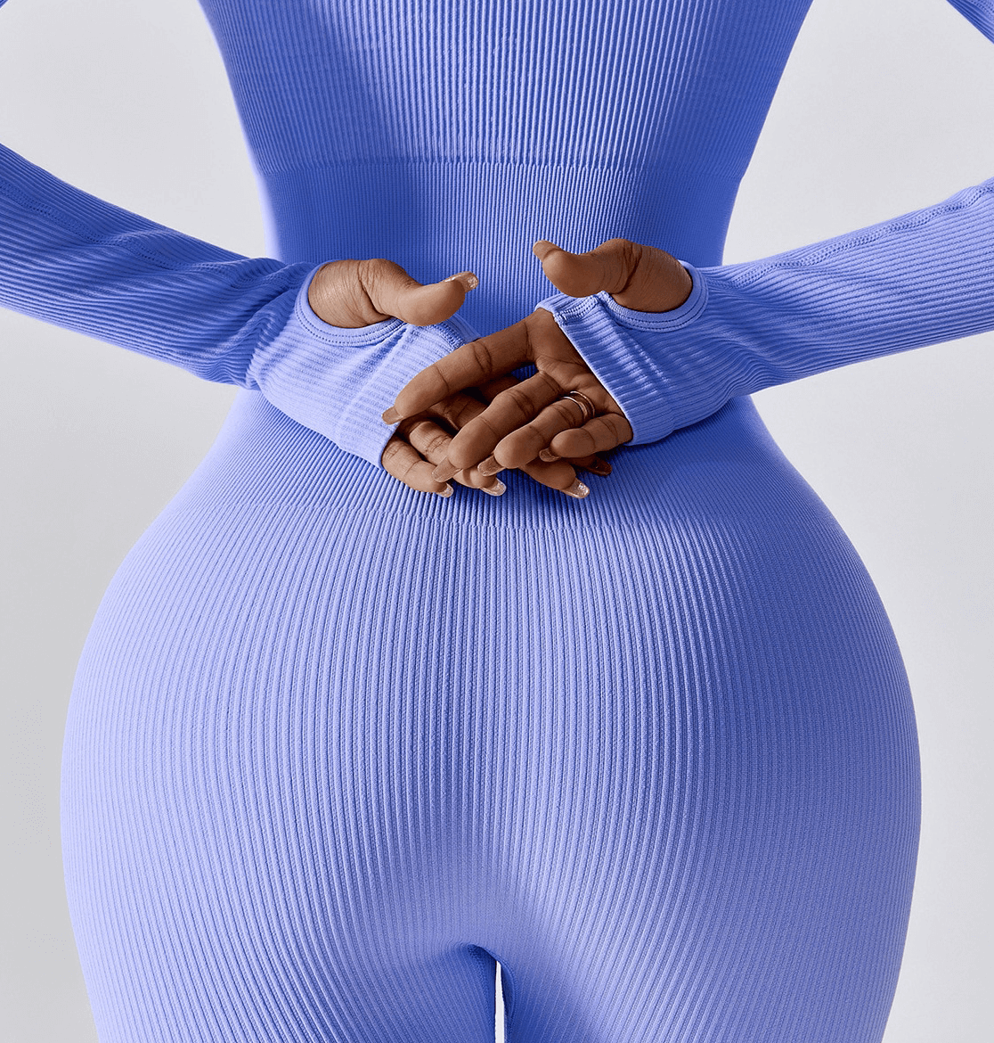 Purple seamless yoga suit with thumb holes for women, back view, showcasing sleek fit and practical sleeve design for workouts